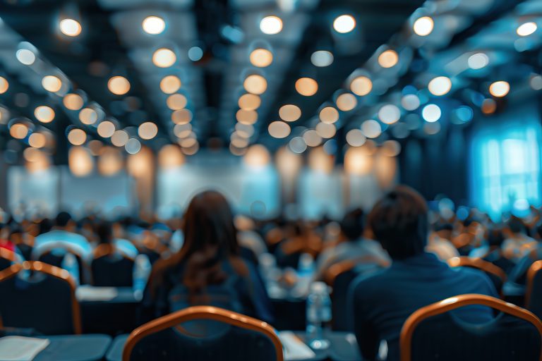 blurred photo of conference hall or seminar room with attendee background