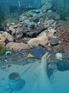 Picture of a woman sitting casually outside with a coffee mug
